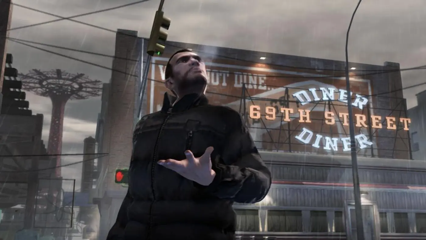 Niko Bellic in a black jacket, in the rain, looking up at the 69th Street Diner sign in Liberty City in GTA IV