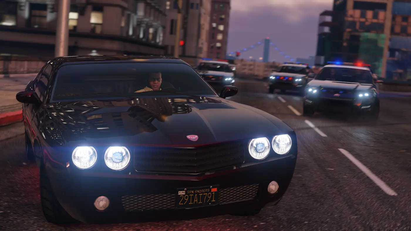 The driver of a black muscle car tearing down a Los Santos avenue at dusk, tailed by a swarm of police cars with their lights flashing, in GTA 5