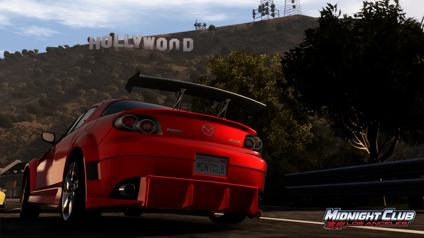 A red Mazda RX-8 with a large rear wing and an MDNTCLB plate, stopped on a hillside road in front of the Hollywood sign, in Midnight Club: Los Angeles.