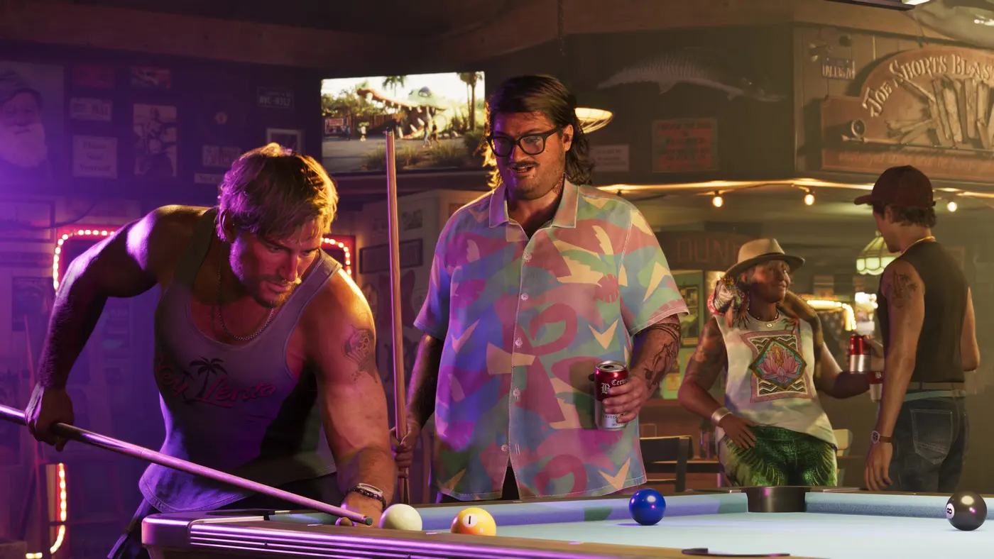 Interior of a neighborhood bar in GTA VI: two men around a pool table under purple neon, one leaning in to take his shot, the other holding a can of beer, surrounded by walls covered in posters and a mounted fish