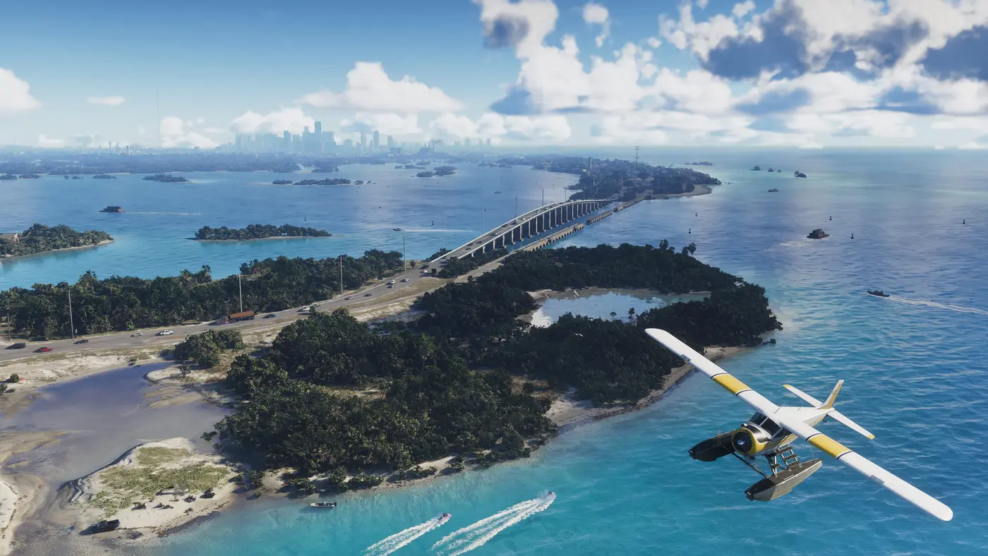 Aerial view of the Leonida Keys in GTA VI: a white and yellow seaplane banks over a turquoise archipelago, speedboats leave wakes and cars travel across a long causeway, Vice City skyline in the distance