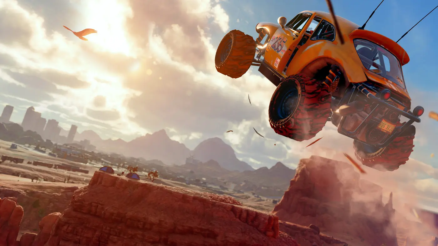 An orange off-road buggy numbered 235 flying through the air over red desert rocks in Saints Row, with a city and mountains visible in the distance under a sunny, cloudy sky